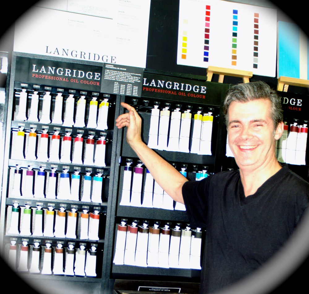 David in front of his beautiful oil paints