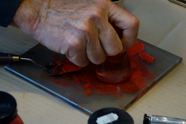 The hands of Dominique Sennelier making oil paint